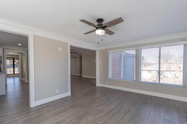 empty room with crown molding, dark wood-type flooring, and ceiling fan