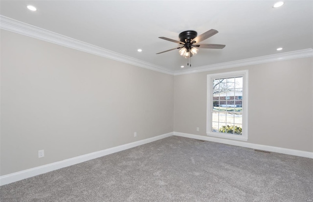 carpeted empty room featuring ornamental molding and ceiling fan