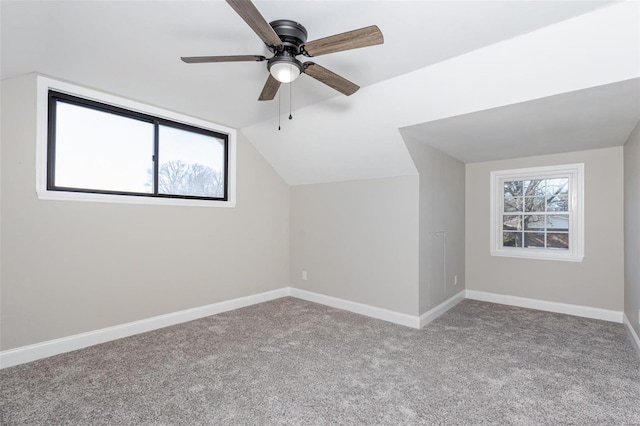 bonus room with ceiling fan, light colored carpet, and vaulted ceiling