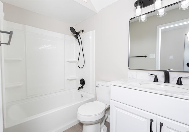 full bathroom featuring toilet, vanity, and bathtub / shower combination