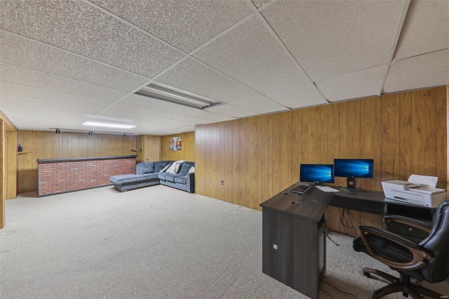 carpeted office space with wooden walls