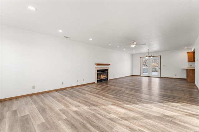 unfurnished living room featuring light hardwood / wood-style floors and ceiling fan