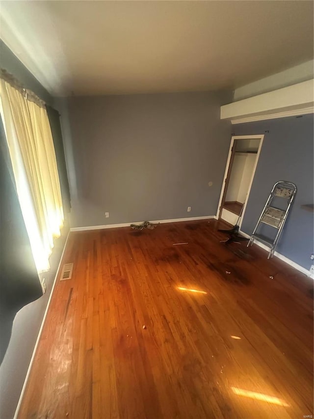 unfurnished room with hardwood / wood-style flooring