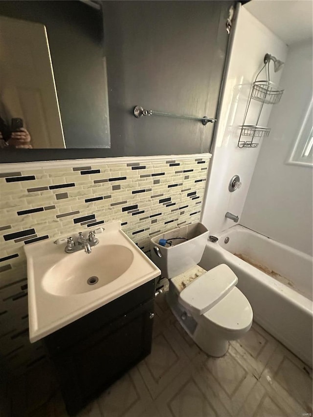 full bathroom featuring shower / bathtub combination, backsplash, toilet, and vanity