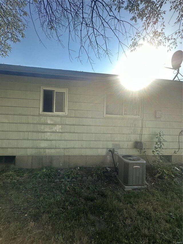 view of side of home with central AC unit