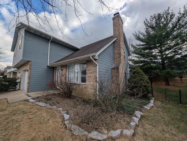 view of home's exterior featuring a yard and a garage