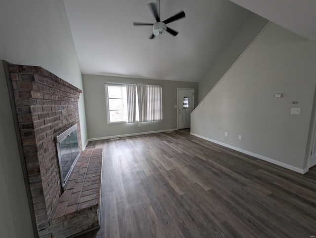 unfurnished living room with ceiling fan, dark hardwood / wood-style floors, a fireplace, and lofted ceiling