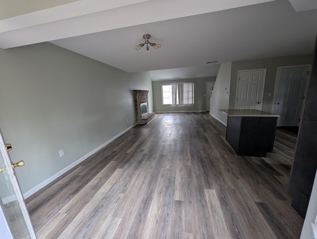 unfurnished living room featuring dark hardwood / wood-style floors and a fireplace