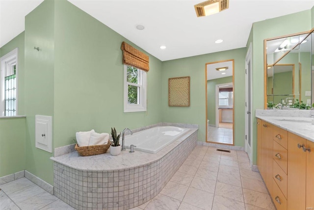 bathroom featuring visible vents, marble finish floor, a bath, and vanity