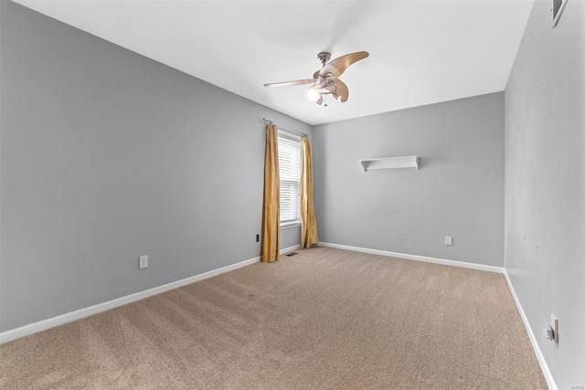 unfurnished room featuring baseboards, a ceiling fan, and carpet