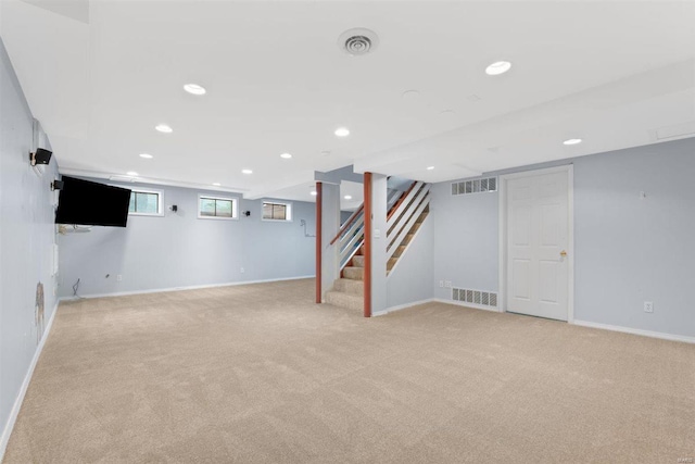 basement featuring recessed lighting, visible vents, light carpet, and stairway