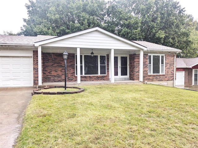 ranch-style home with a front lawn, covered porch, and a garage