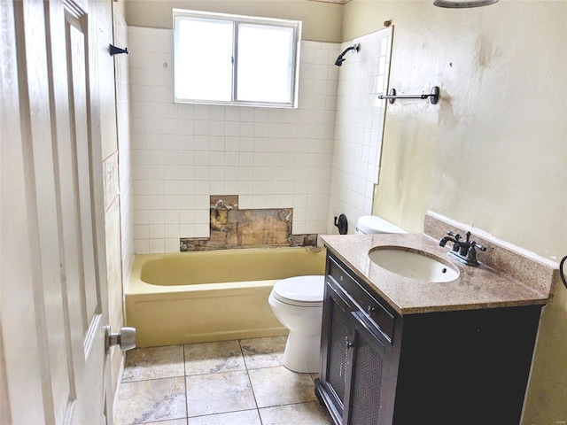 full bathroom featuring tiled shower / bath combo, vanity, and toilet