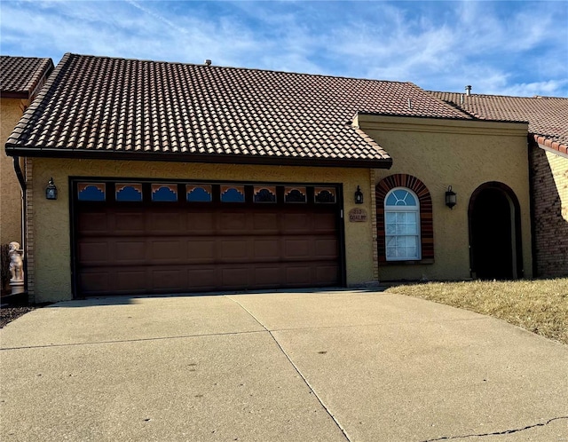 mediterranean / spanish home with a garage