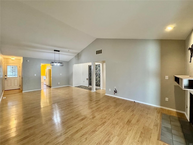 unfurnished living room with lofted ceiling and light hardwood / wood-style flooring