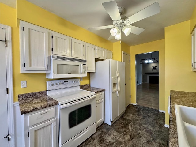 kitchen with white cabinetry, sink, ceiling fan, and white appliances