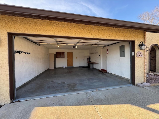 garage with a garage door opener and electric panel