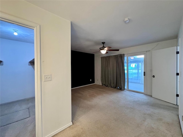 unfurnished living room with light carpet and ceiling fan