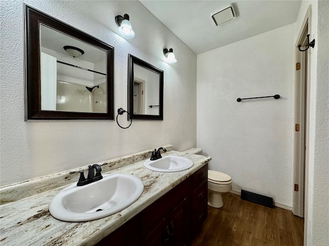 bathroom featuring vanity, hardwood / wood-style floors, and toilet