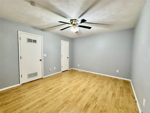 spare room with light hardwood / wood-style flooring and ceiling fan