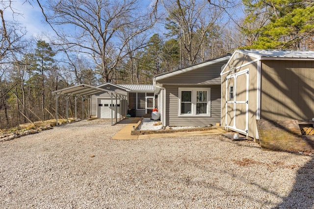 exterior space featuring a carport, a garage, and an outdoor structure