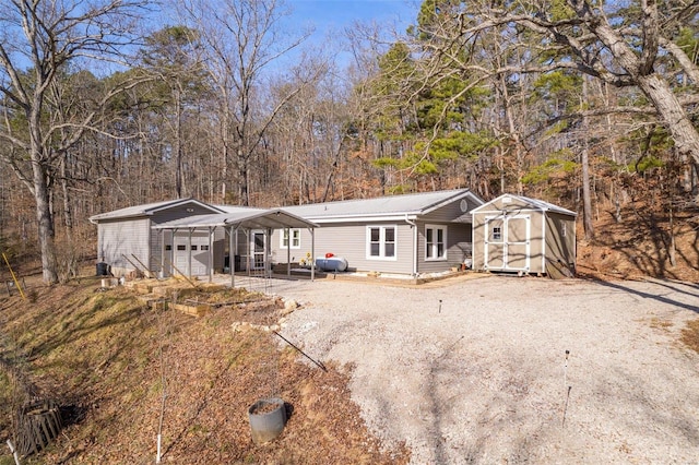 view of front of house featuring a shed and a carport