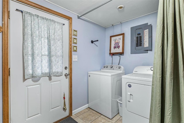 laundry area with electric panel, washing machine and dryer, and light tile patterned floors