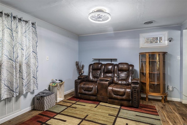 home theater with ornamental molding and dark hardwood / wood-style flooring