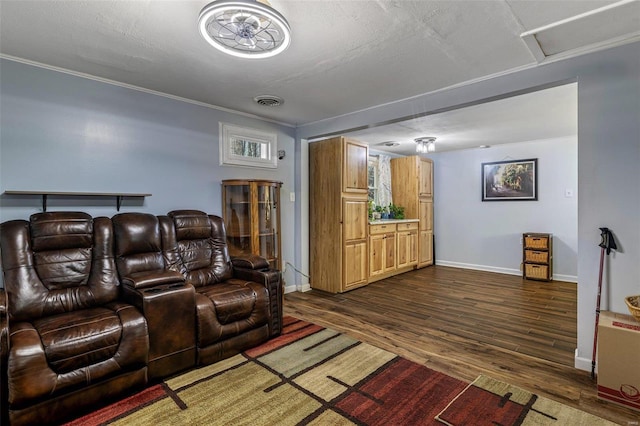 home theater with ornamental molding, dark hardwood / wood-style floors, and a textured ceiling