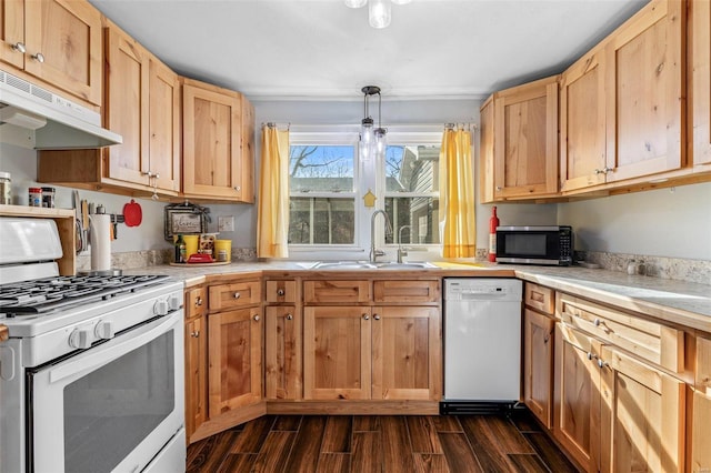 kitchen with pendant lighting, sink, white appliances, and dark hardwood / wood-style flooring