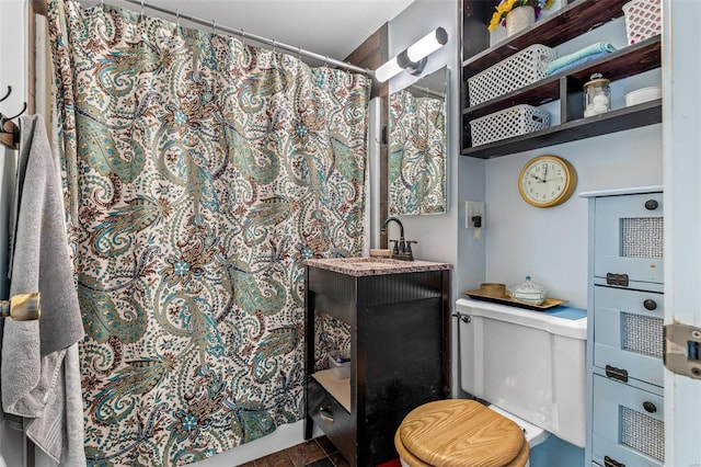 bathroom with walk in shower, vanity, and toilet