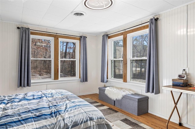 bedroom with hardwood / wood-style flooring and ornamental molding