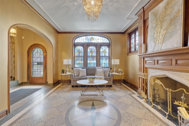 living area with ornamental molding, a premium fireplace, a high ceiling, and a wealth of natural light