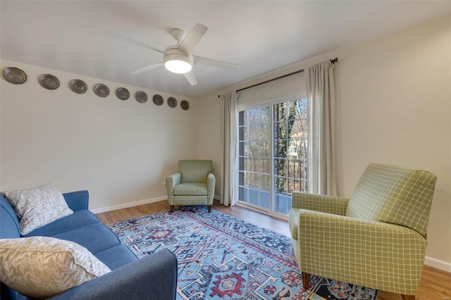 living room featuring hardwood / wood-style flooring and ceiling fan