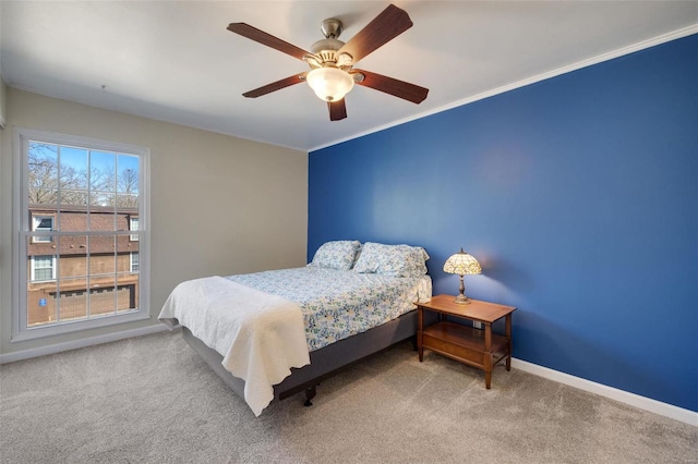 bedroom featuring crown molding, ceiling fan, and carpet flooring