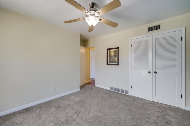 unfurnished bedroom featuring light colored carpet, ceiling fan, and a closet