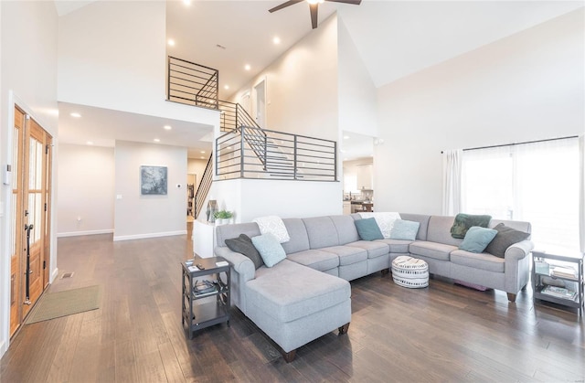 living room with high vaulted ceiling, dark hardwood / wood-style flooring, and ceiling fan