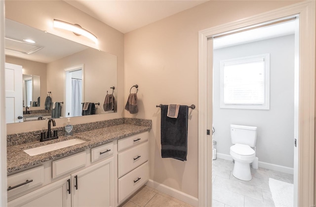 bathroom with tile patterned floors, vanity, and toilet