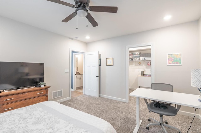 carpeted bedroom featuring ceiling fan and connected bathroom