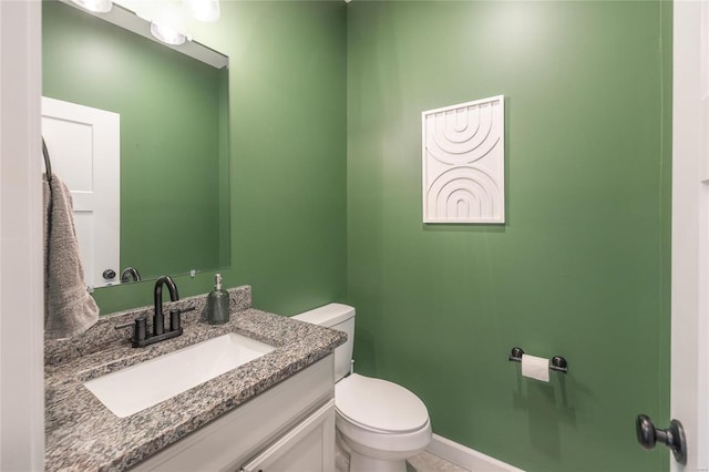 bathroom with toilet and vanity