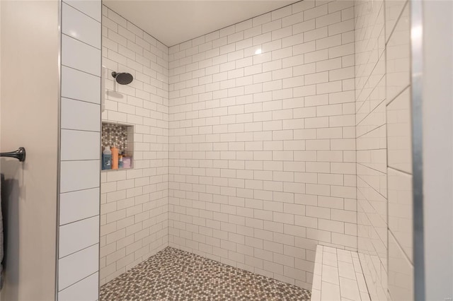 bathroom with tiled shower