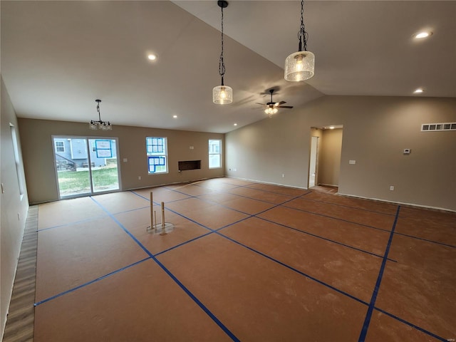 unfurnished living room with ceiling fan and vaulted ceiling