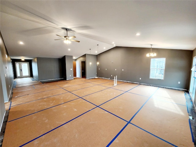 interior space featuring lofted ceiling and ceiling fan with notable chandelier