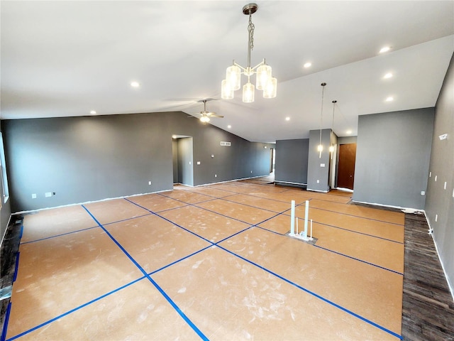 unfurnished living room with vaulted ceiling and ceiling fan with notable chandelier