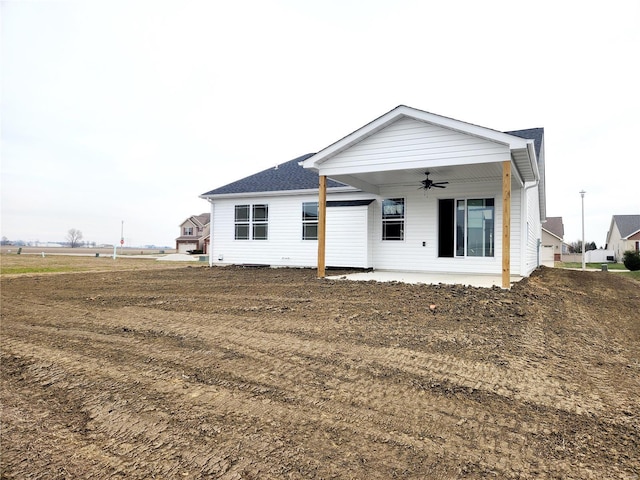 back of house featuring ceiling fan, a patio area, and a yard