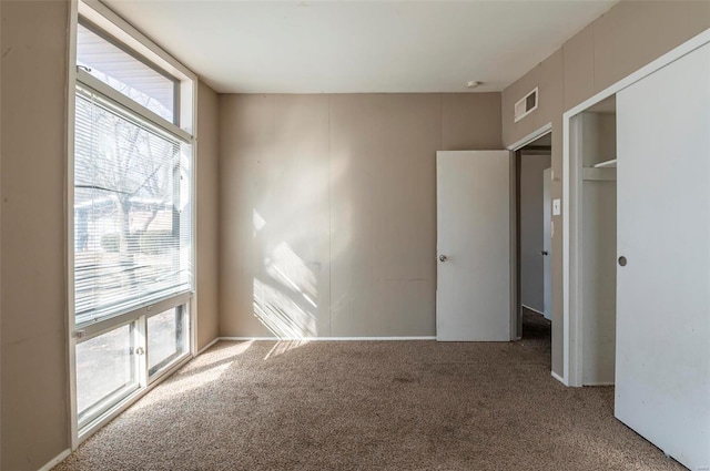 unfurnished bedroom featuring carpet flooring and a closet