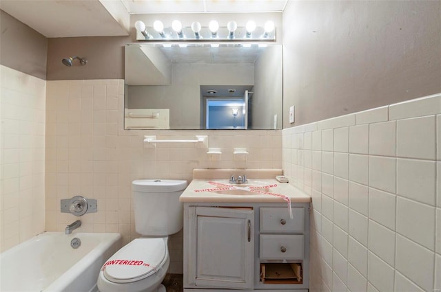 full bathroom with washtub / shower combination, vanity, toilet, and tile walls