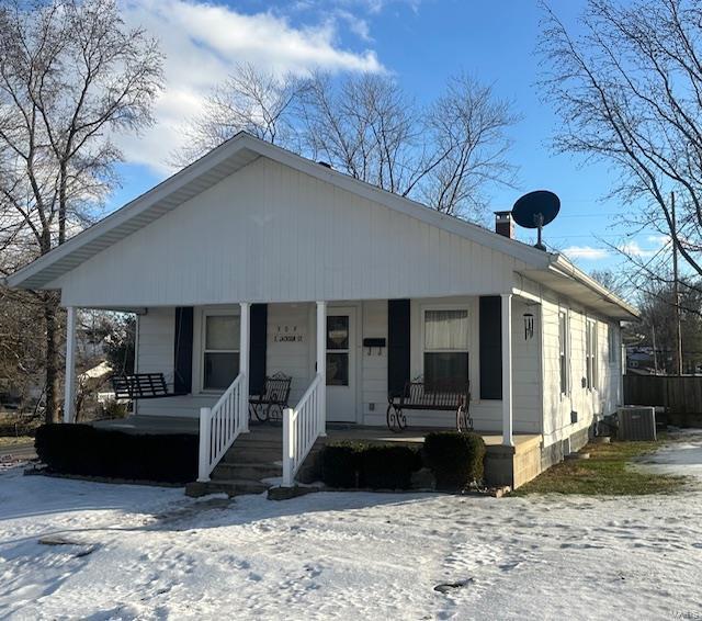 bungalow with central AC unit and covered porch