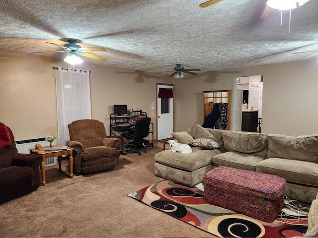 carpeted living room with a textured ceiling and ceiling fan