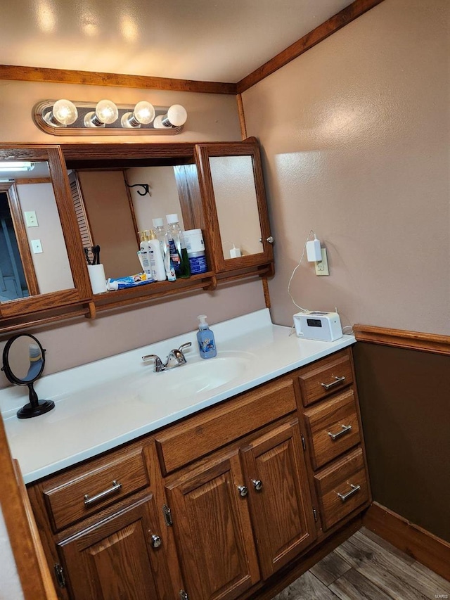 bathroom with hardwood / wood-style floors and vanity